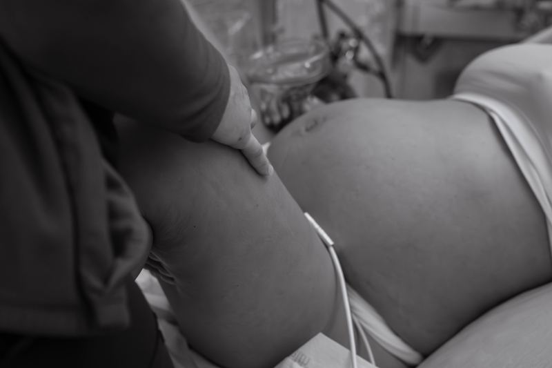 A supporting hand resting between contractions